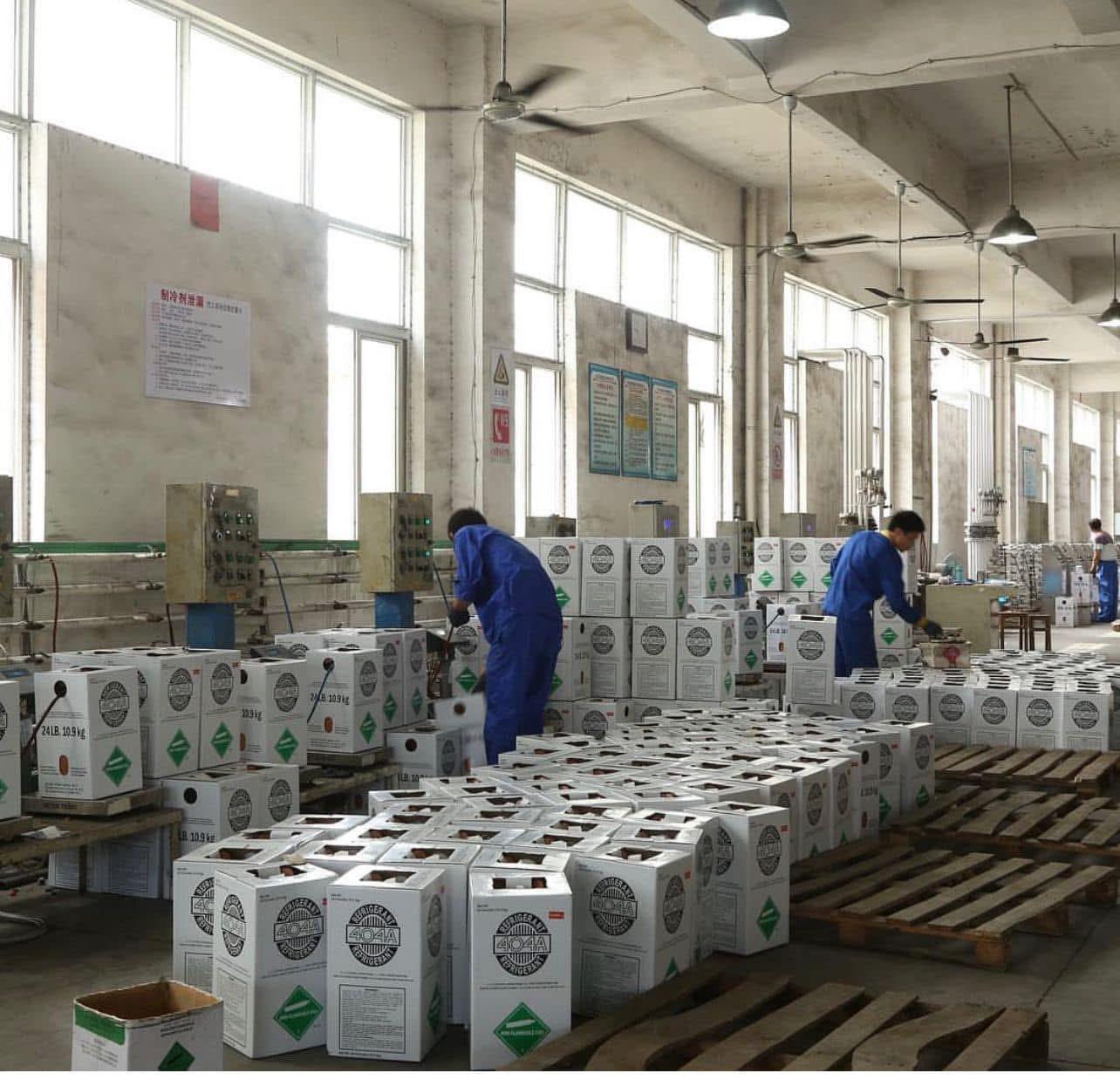 Refrigerant cylinders being filled and packed on the production line